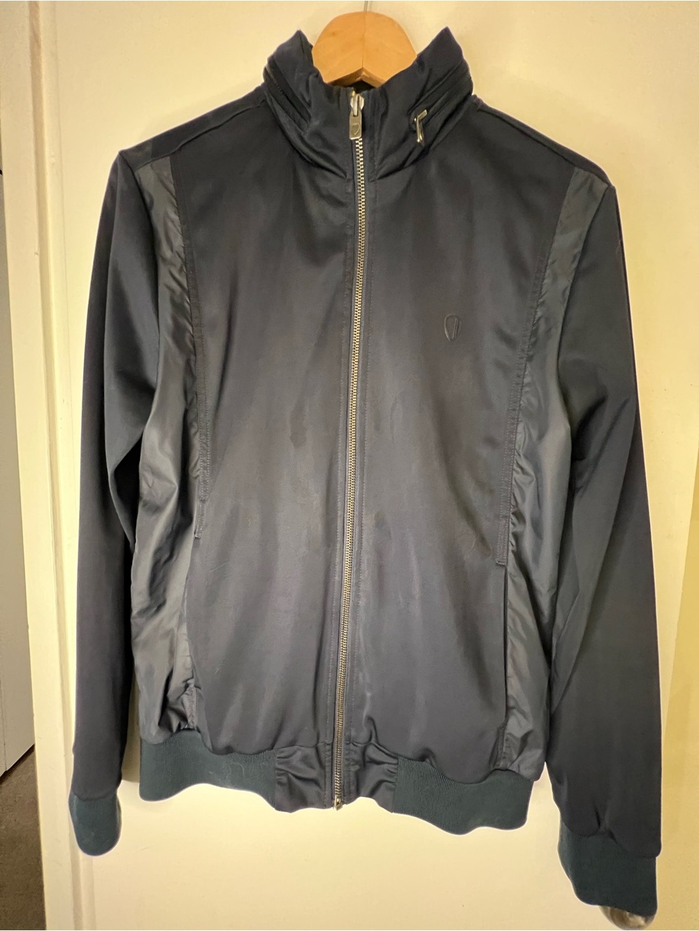 Men's Navy Full-Zip Lightweight Jacket with hideaway, zipper-enclosed hood.